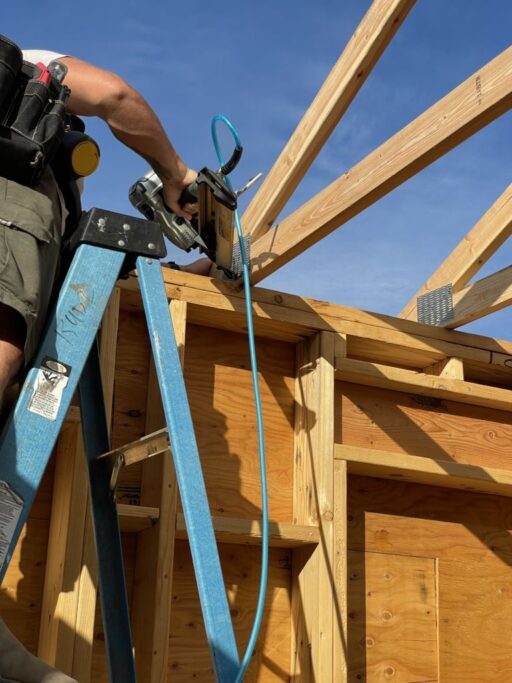 Person using nail gun.